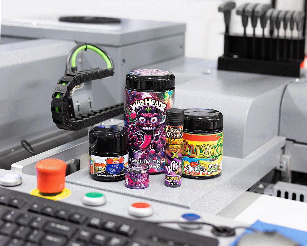 Colorful embellished jar labels sitting on our embellishment machine.