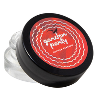 Small jar with a black lid featuring 'garden party' branding on a white background